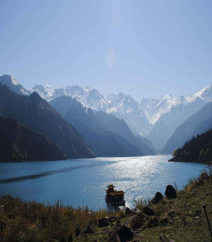 Mirror-like reflections of Tianshan peaks on the waters of Heavenly Lake.