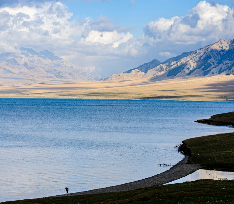 Serene lakeside view with still waters and natural scenery.