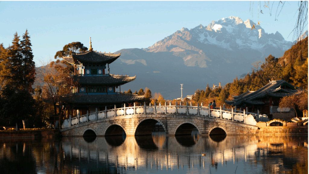 Cobblestone bridges and canals in Lijiang Old Town, showcasing traditional Naxi and Tibetan architecture.