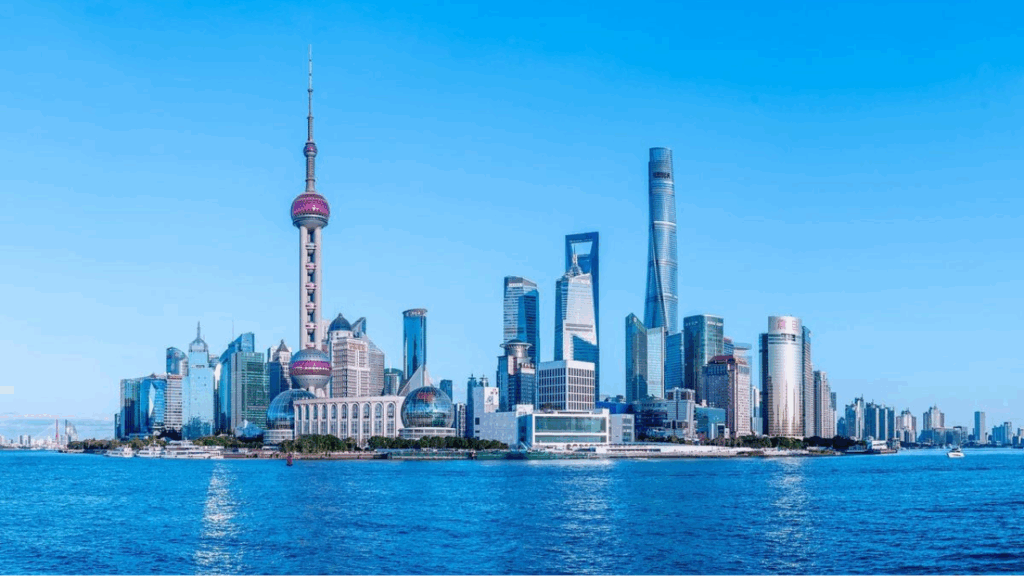 The Bund in Shanghai with tall skyscrapers and modern architecture along the Huangpu River.