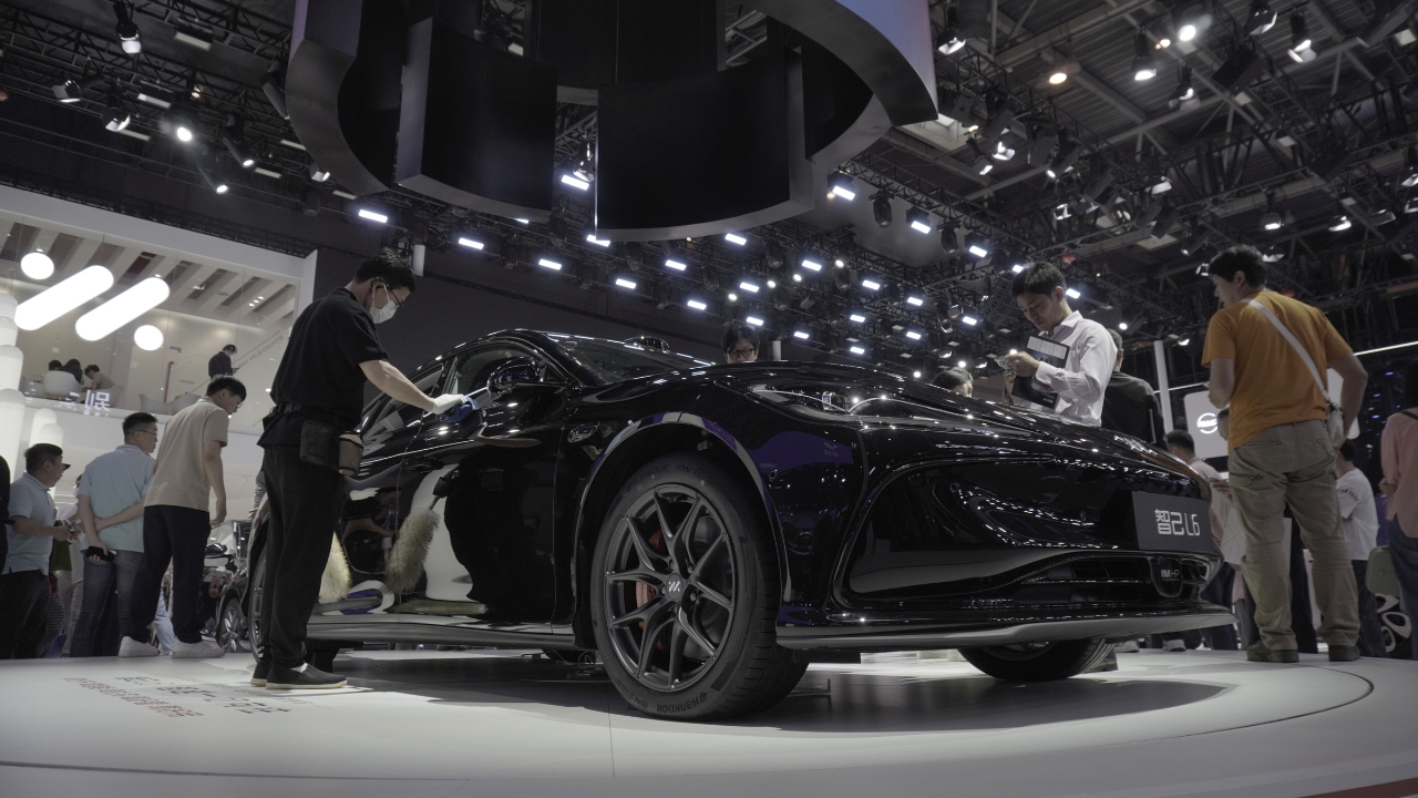 Black car displayed at a China auto show, showcasing the latest automotive innovations at a 2025-2026 event