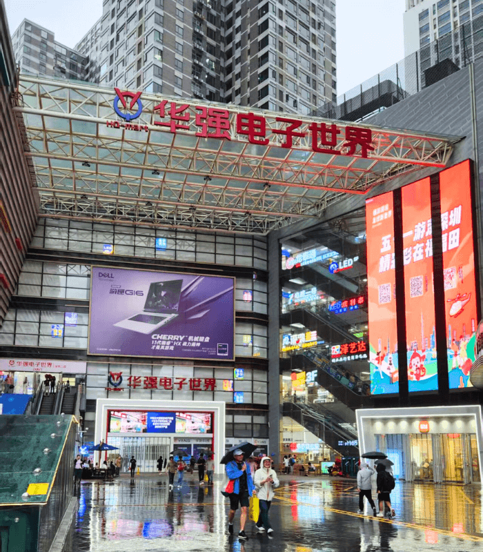 Exterior of Huaqiangbei Electronics Building with shoppers at entrance