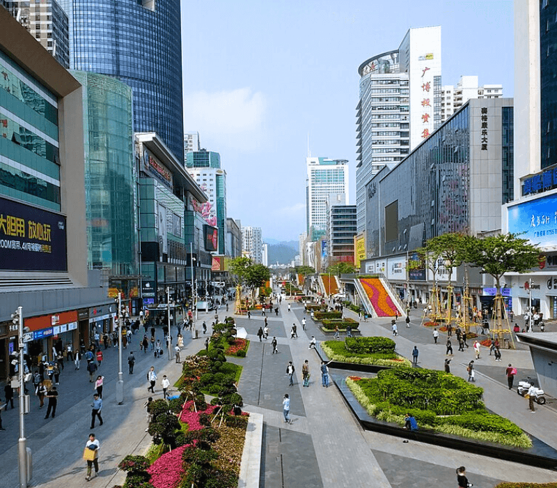 Shoppers browsing tech gadgets on busy Huaqiangbei Street in Shenzhen