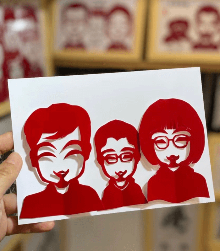 Traditional Chinese paper cutting of a family portrait