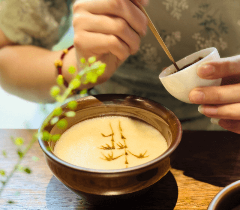 Cultural tea whisking experience during a heritage tour in Shanghai