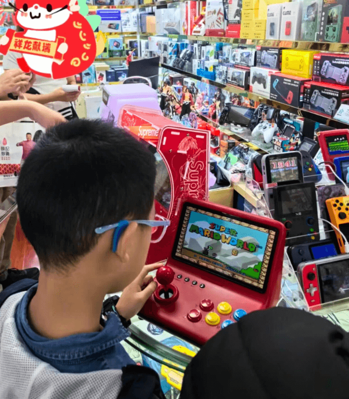 Assortment of gaming electronics on display in Yiwu market booth