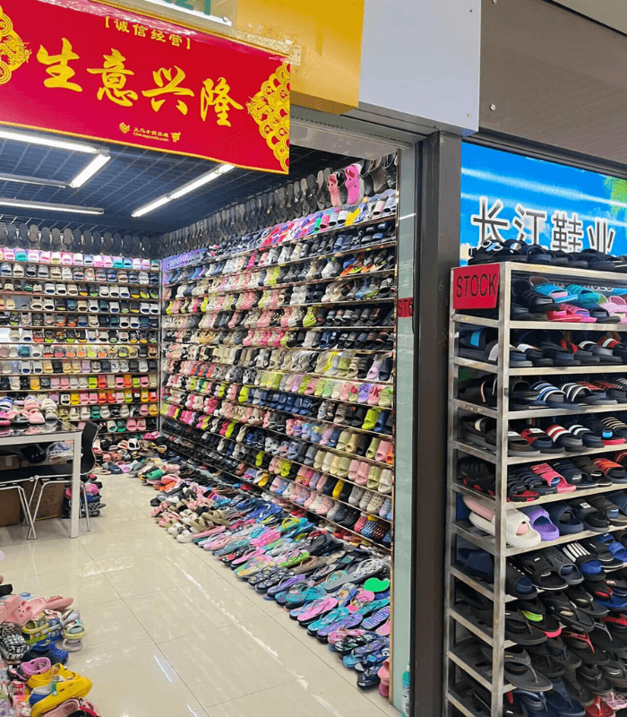 Visitor sourcing slippers inside Yiwu International Trade City market
