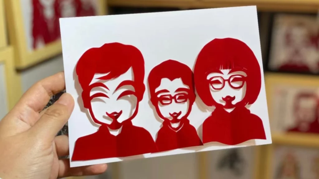 Traditional Chinese red paper cutting family portrait
